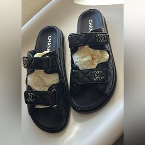 CHANEL Black Quilted Slides with Silver Accents